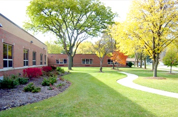 Lawn behind a building with trees